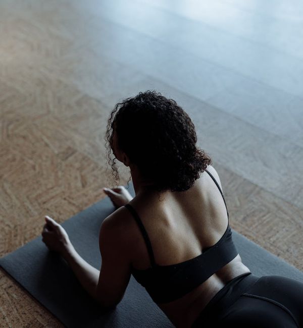Calm athlete meditating on a yoga mat after a workout.